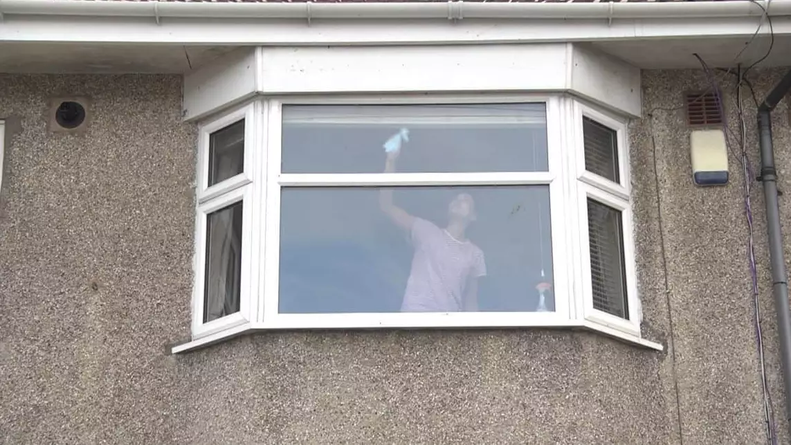 The Photograph Of A Woman Cleaning A Window Is More Sinister Than You Think