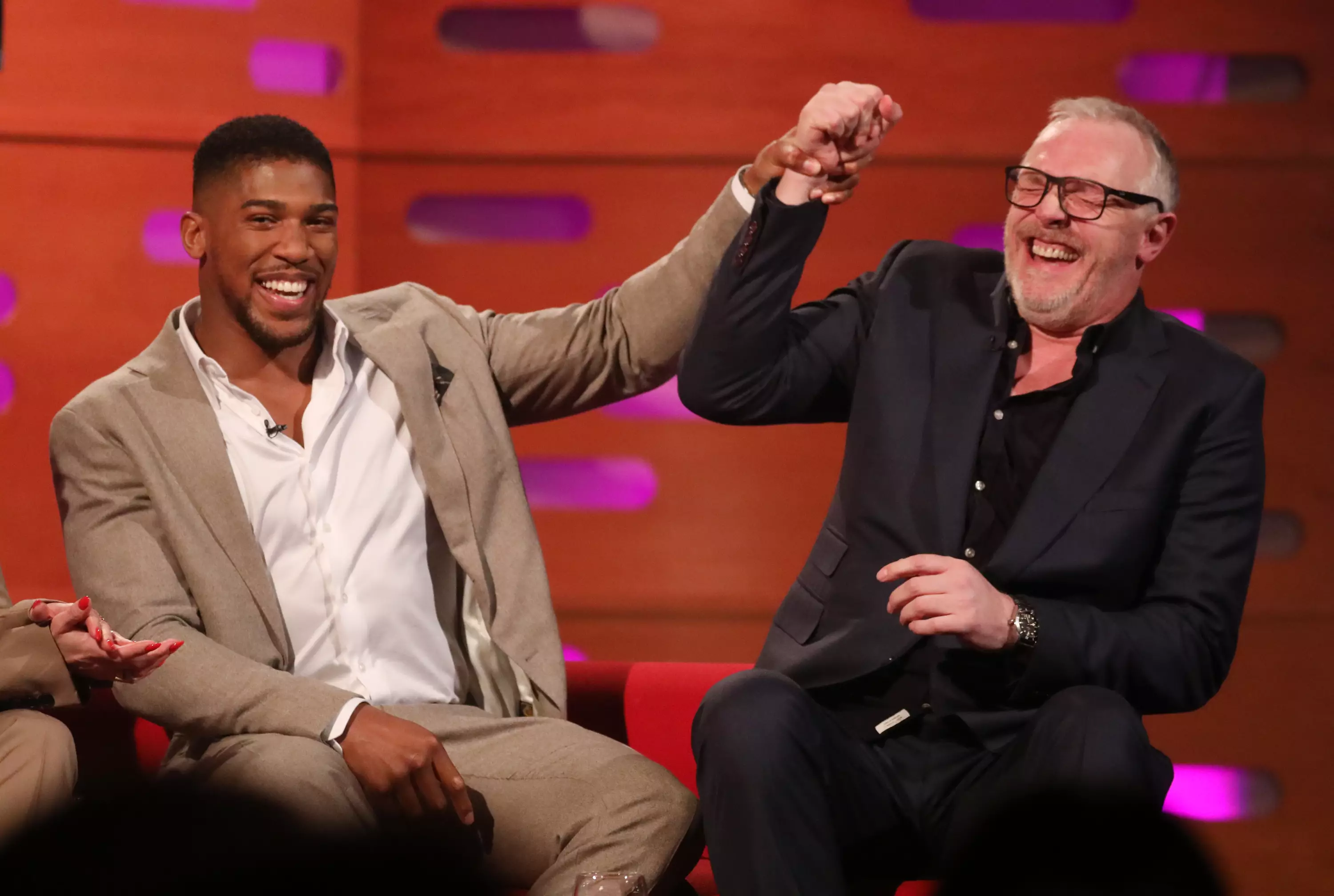 Greg Davies laughs after beating Anthony Joshua in the hammer challenge.