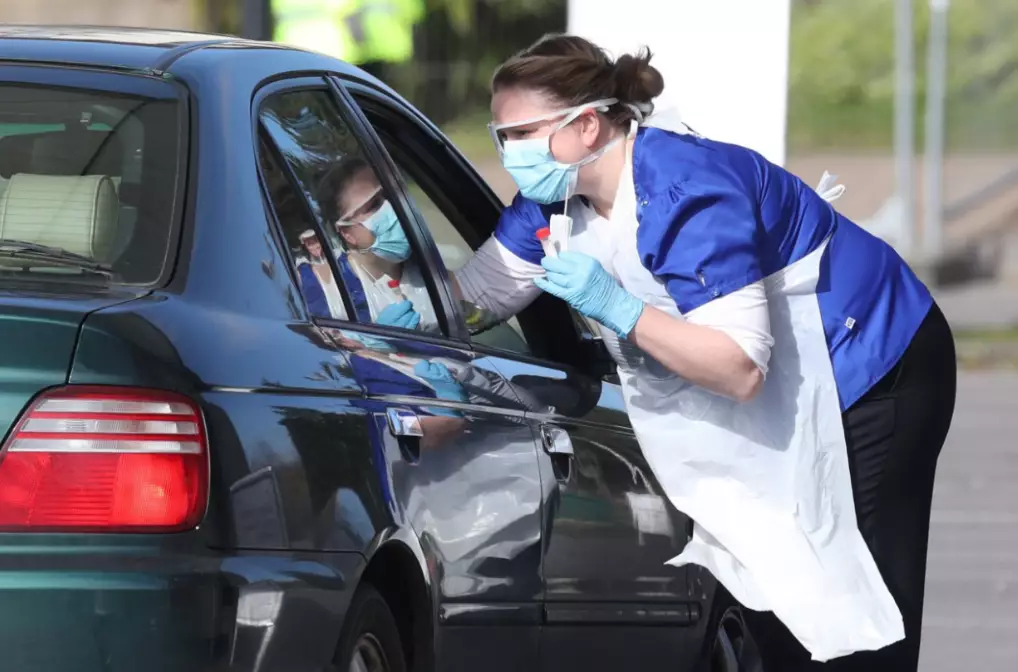 Medical staff taking samples at an NHS drive-through testing facility at Chessington World of Adventures, Greater London.