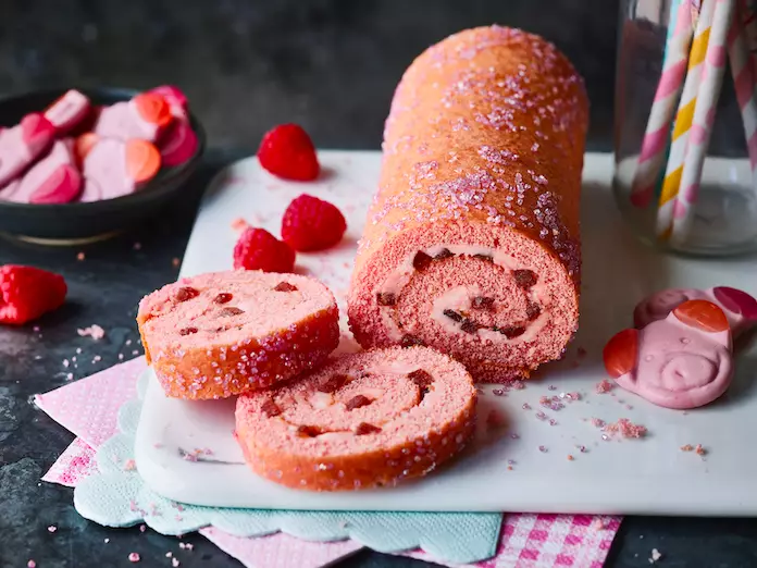 The pink fluffy Swiss Roll is filled with Percy Pig flavoured buttercream (