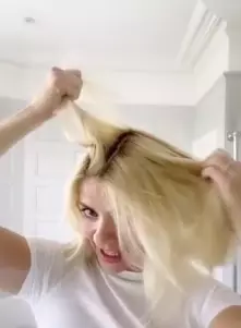 Holly showed her dark roots at the start of the video (