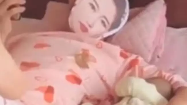 Dad Wears Mask Of Wife's Face And Her Pyjamas To Stop Their Baby Crying