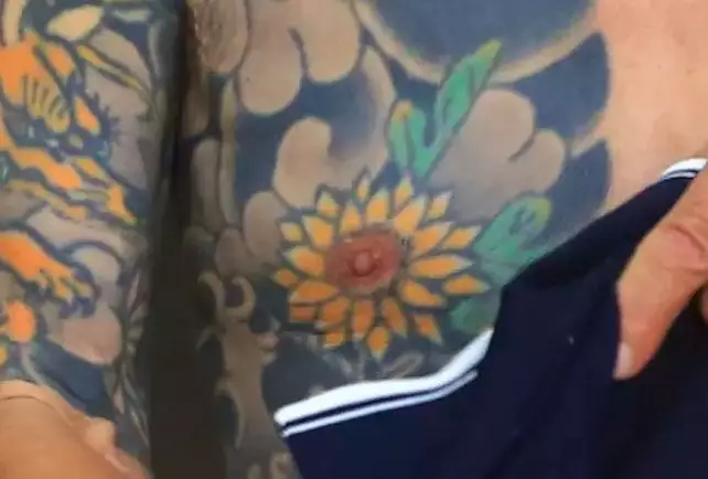 The flower around his nipple.