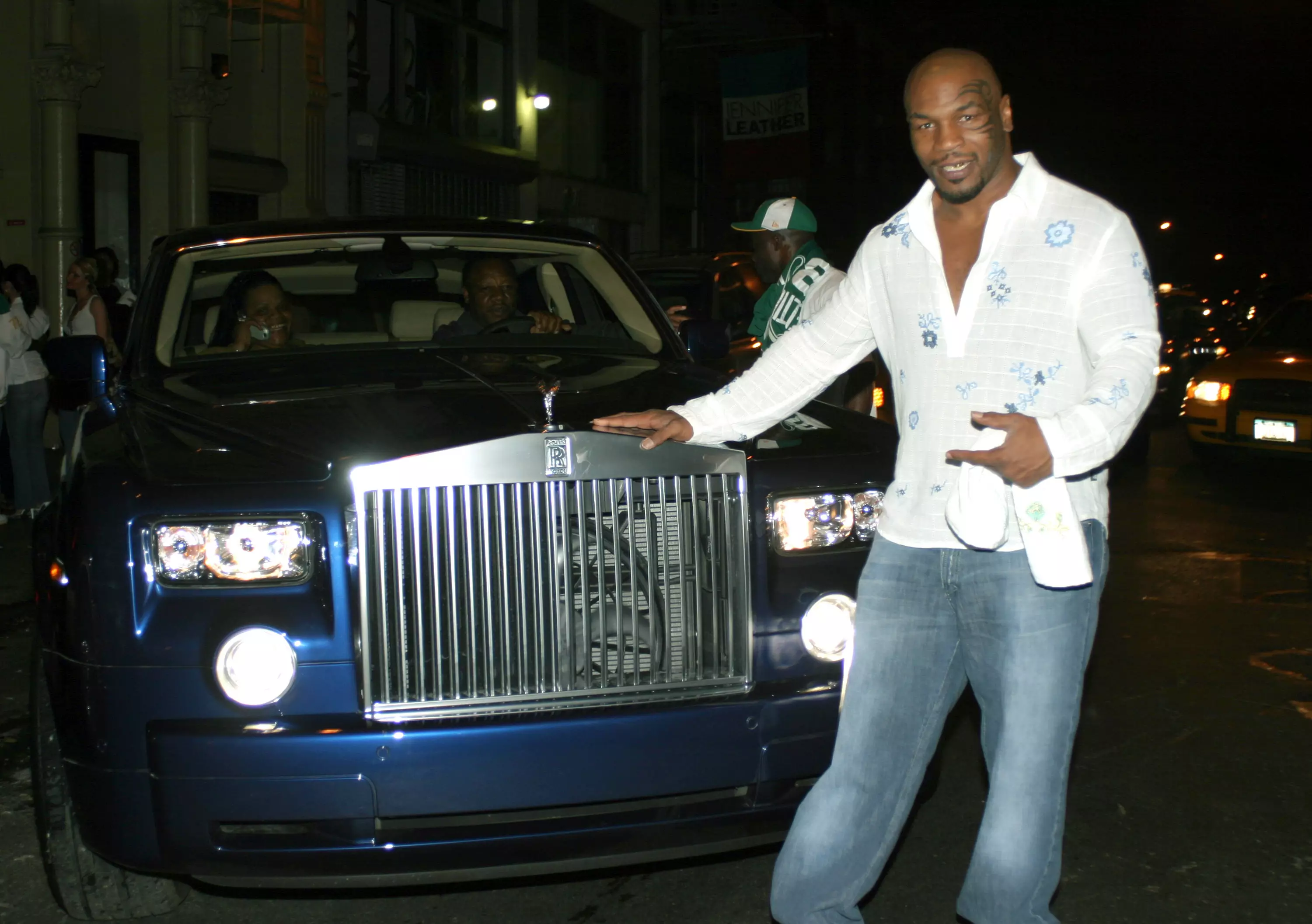 Mike Tyson poses with one of his Rolls-Royce cars.