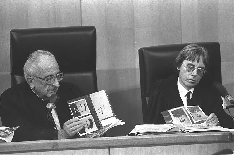 Supreme court justice Dov Levin and district court judge Dalia Dorner looking at a photo album during the trial of John Demjanjuk in jerusalem (