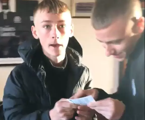 He realises that the scratchcard is a winner...