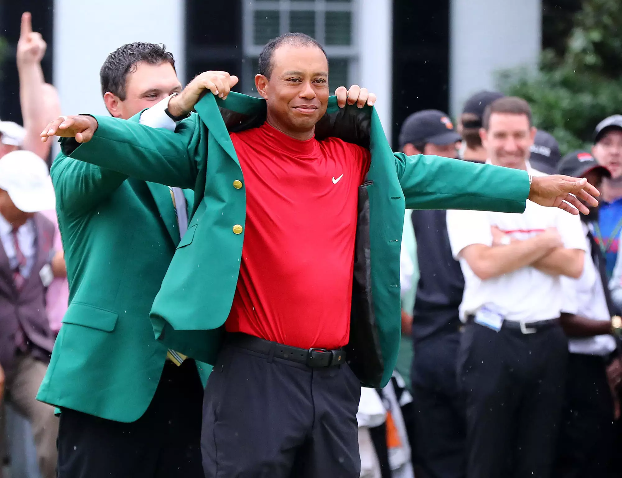 Woods collects his green jacket from Patrick Reed. Image: PA Images