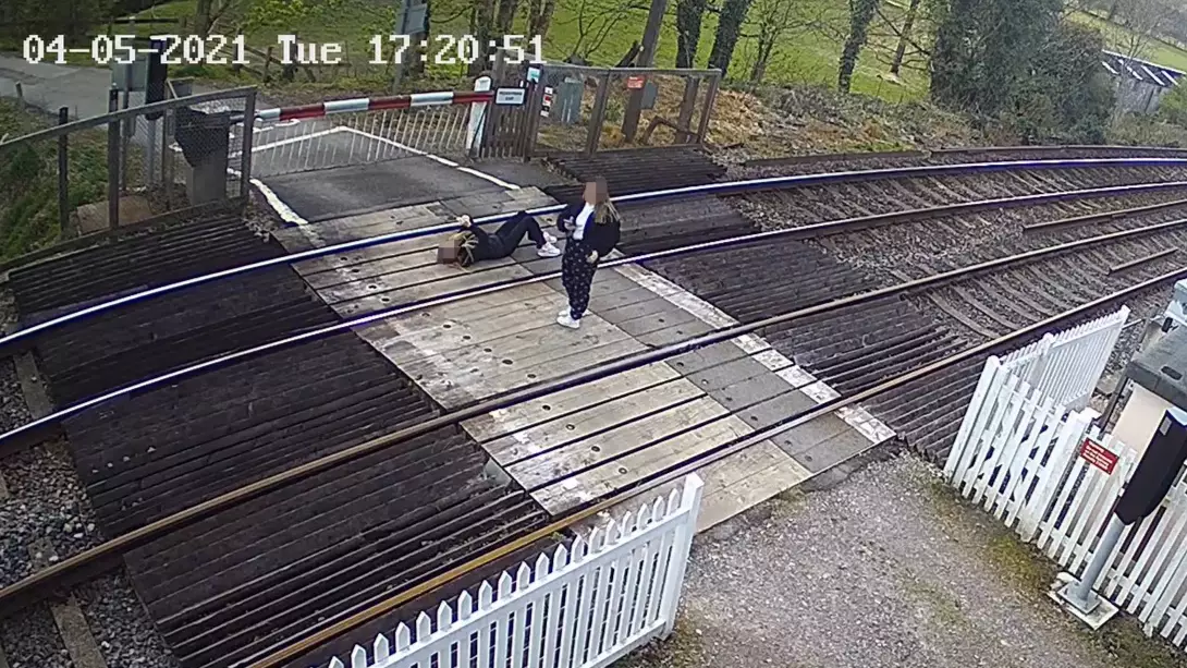 Shocking Moment Girl Lies On Train Tracks While Using Phone