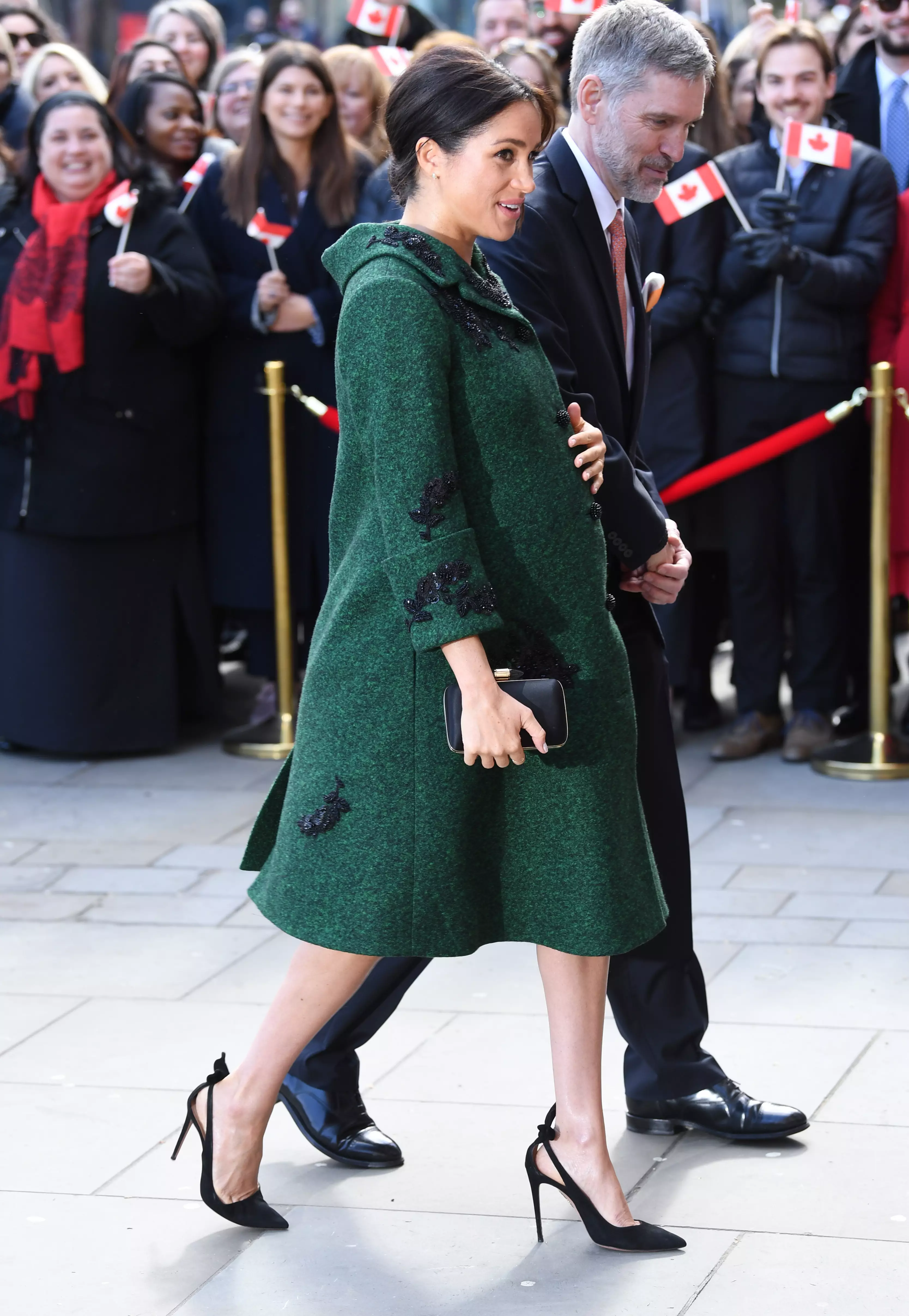Meghan Markle touching her bump while pregnant with baby Archie in March 2019 (