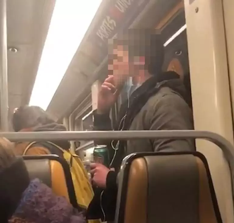 The man was spotted on a subway in Brussels, licking his hand and wiping the handrail.