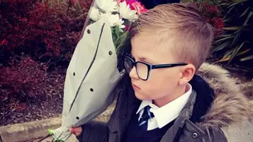 Little Boy Waits At School Gates With Flowers And Chocolates To Win Back Ex-Girlfriend