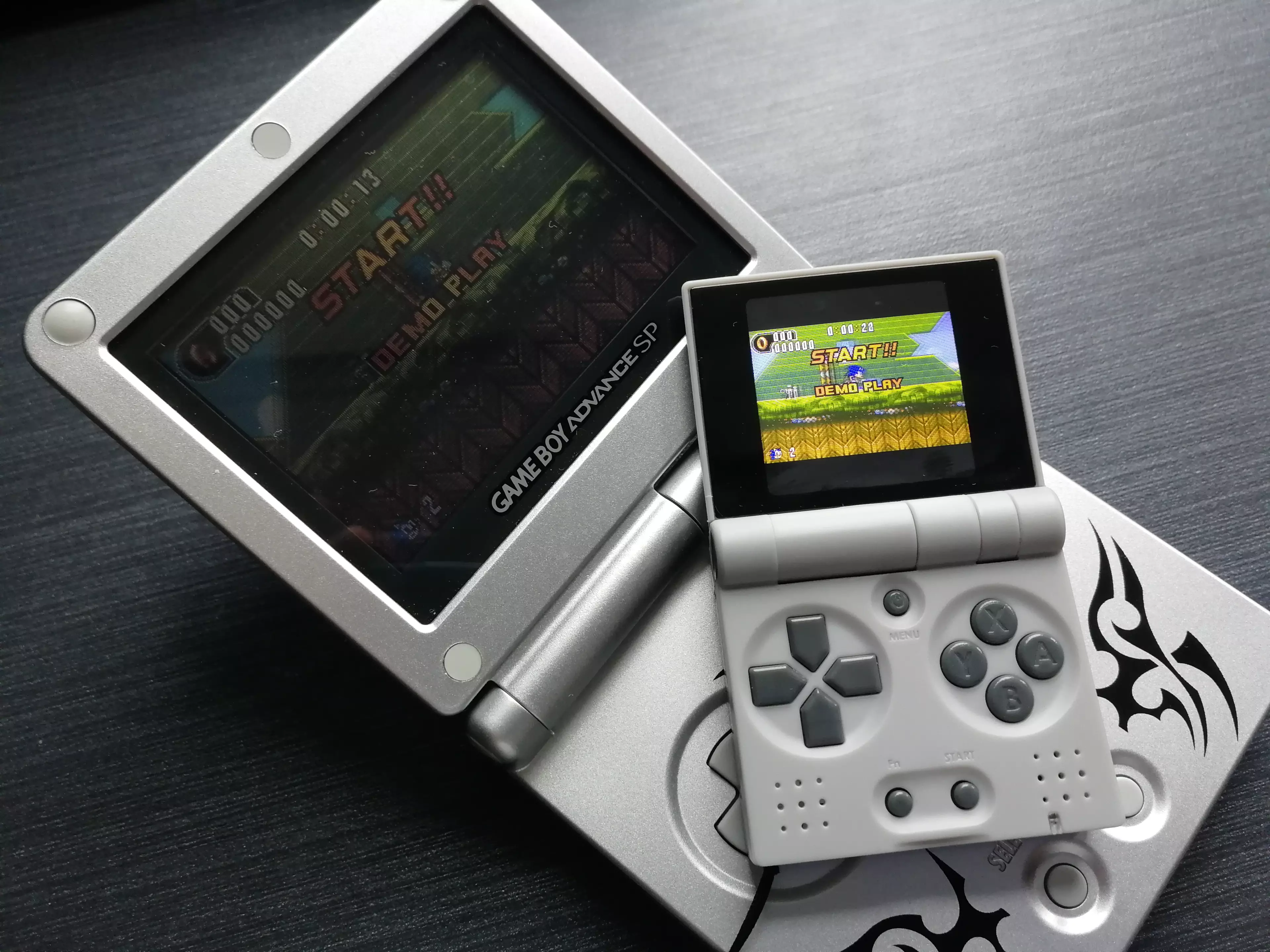 The FunKey S beside its closest influence, the Game Boy Advance SP /