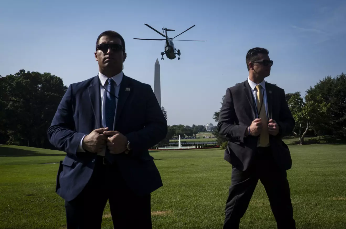Secret Service agents stand watch as President Trump and First Lady Melania Trump depart on Marine One from the South Lawn of the White House earlier this year.