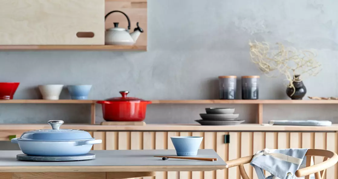 The range features cast iron woks and casserole dishes, stoneware plates and gorgeous serveware (