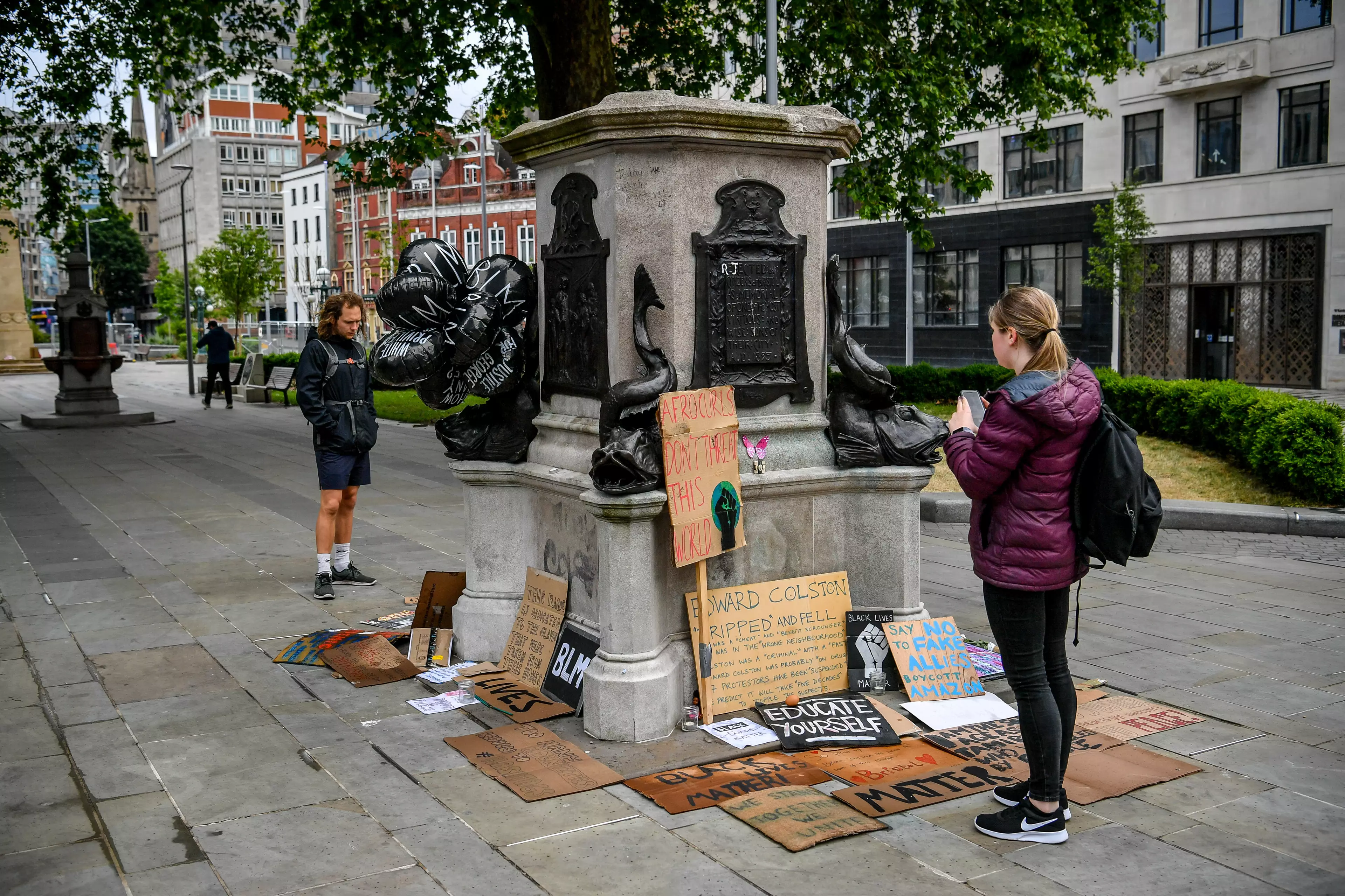 The empty plinth where the Edward Colston statue once stood is now covered in Black Lives Matter placards.