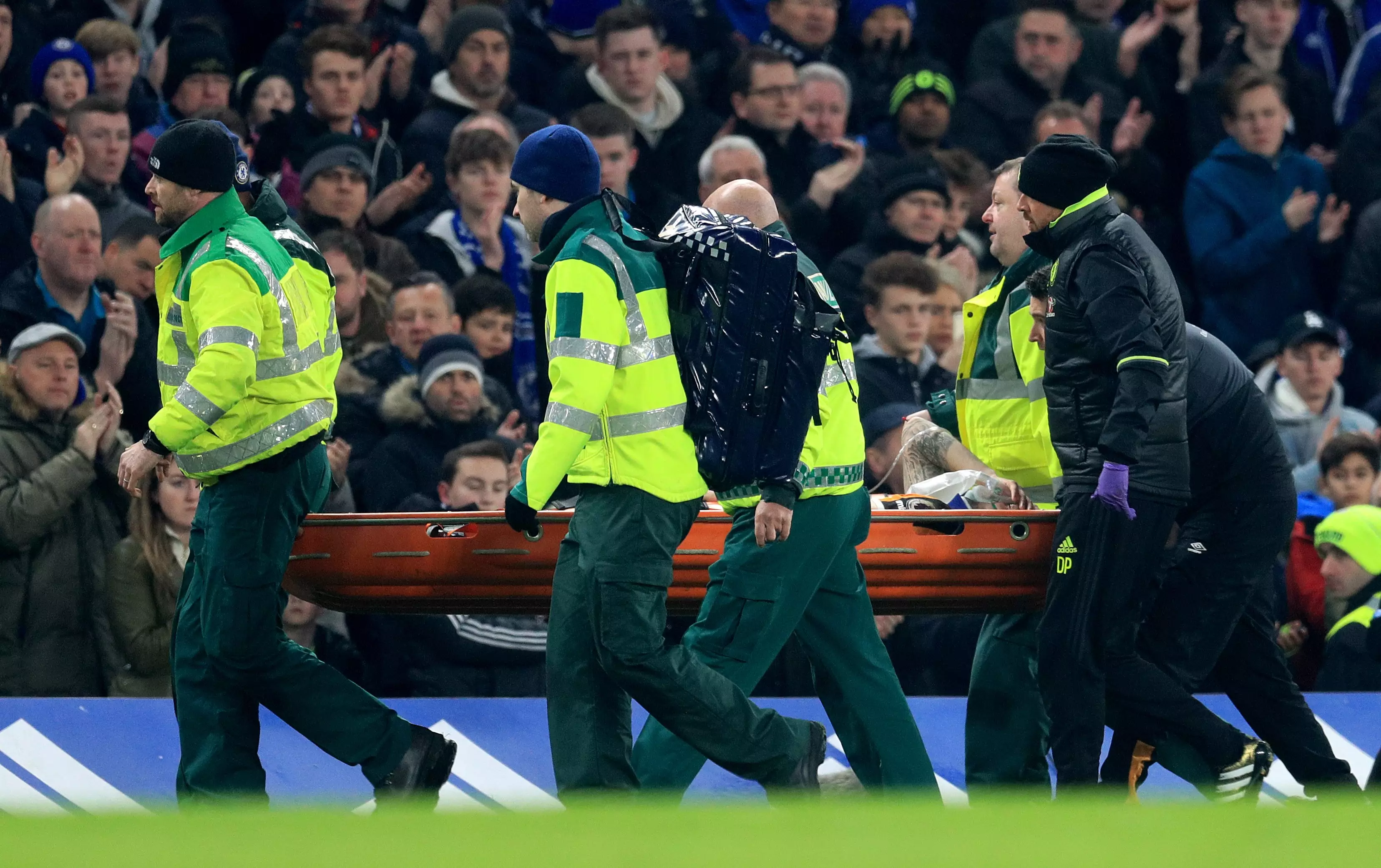 Mason stretchered off after the collision with Cahill. Image: PA Images.