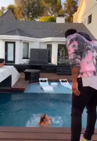 The singer kicked his partner into the pool.