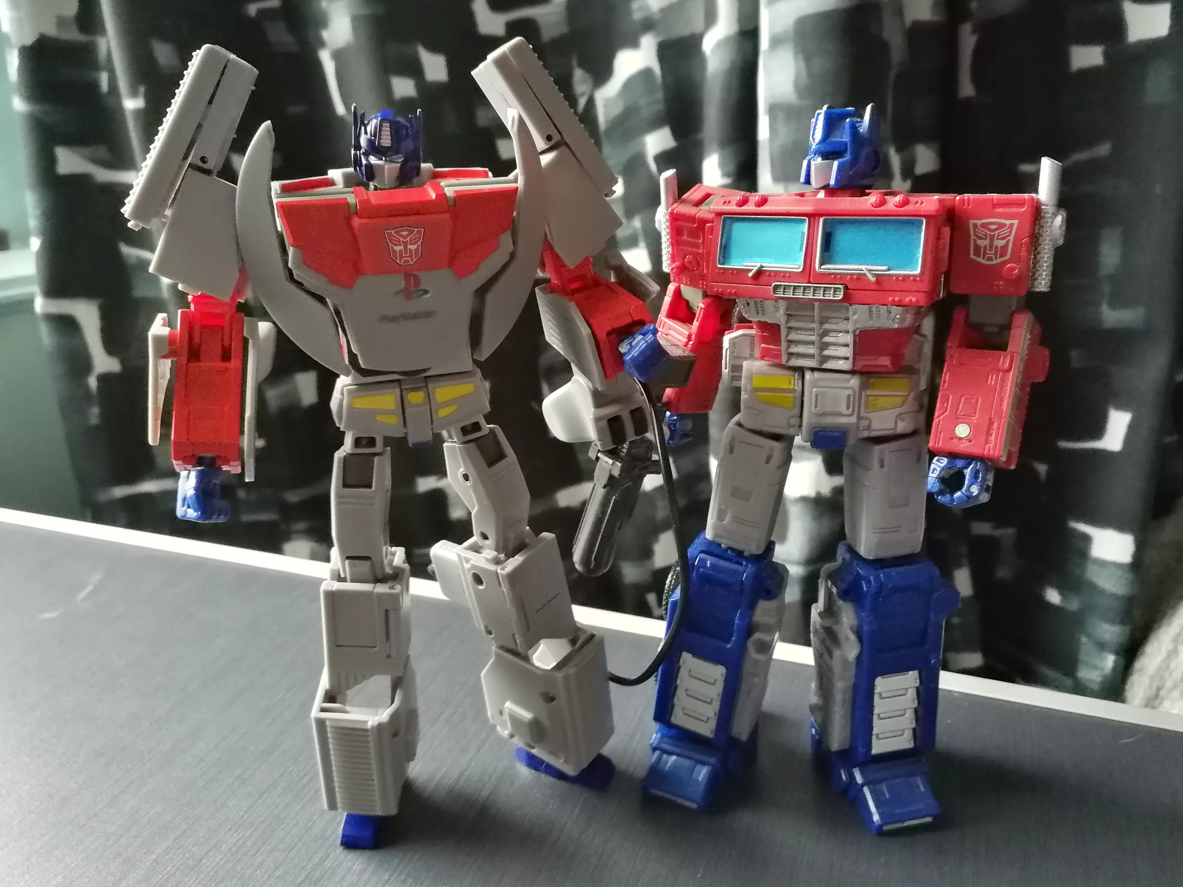 PlayStation Optimus Prime beside the Earthrise-range version of the same character