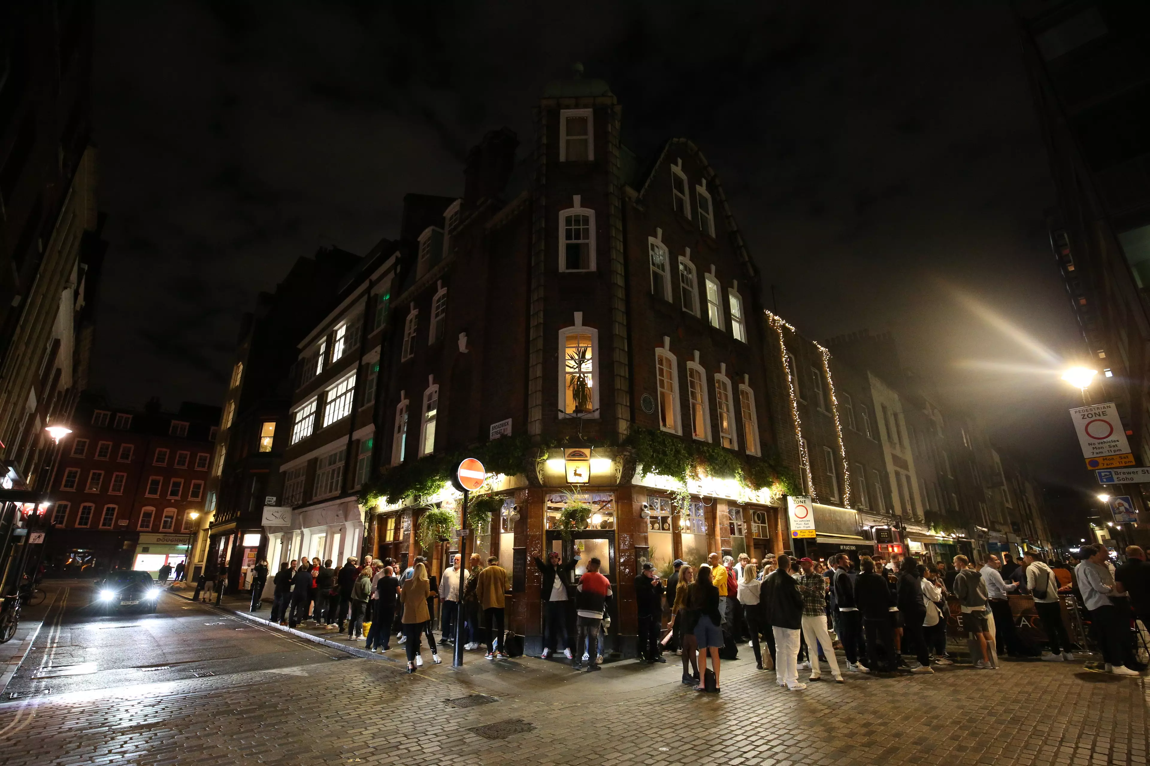 Crowds outside a London pub.