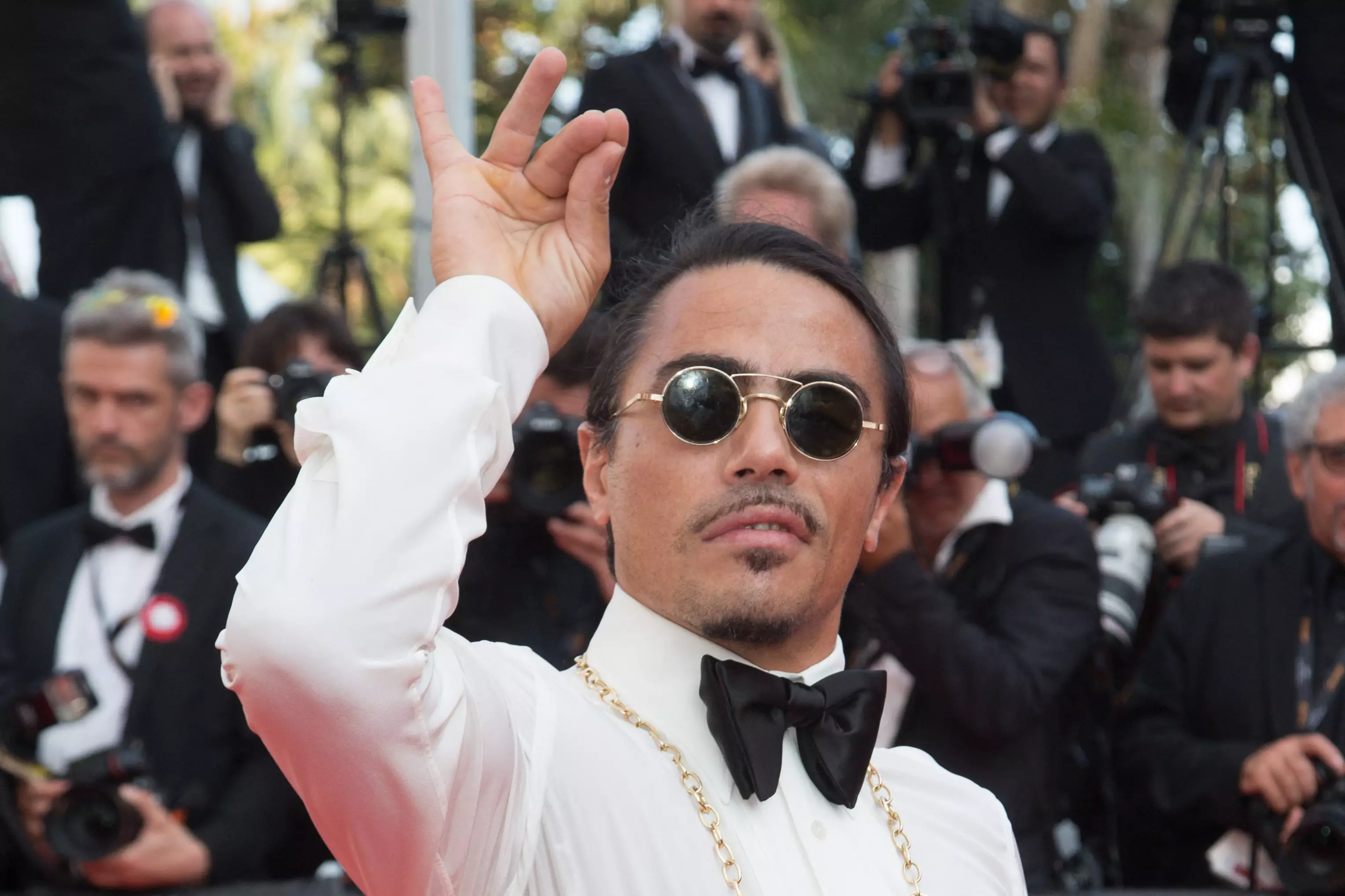 Salt Bae doing his iconic salt sprinkling action on the red carpet at the Cannes Film Festival in 2019. (