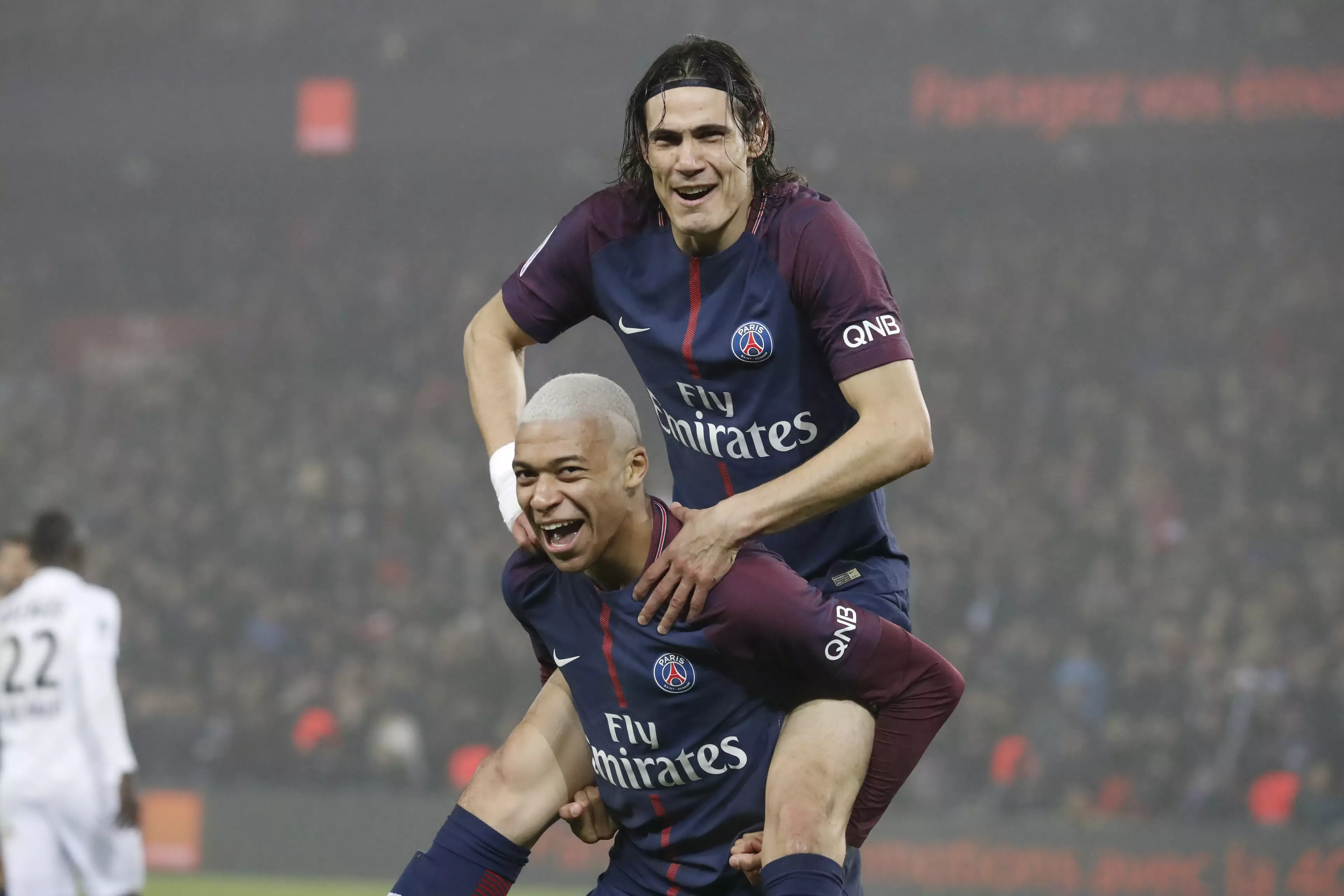 Cavani attempting to ride Kylian Mbappe out of Paris. Image: PA Images.