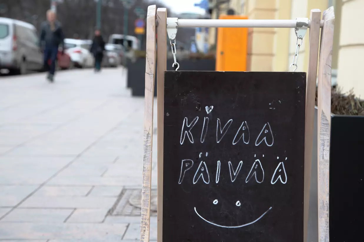A sign in front of a restaurant in Helsinki tells passers-by to 'have a nice day'.