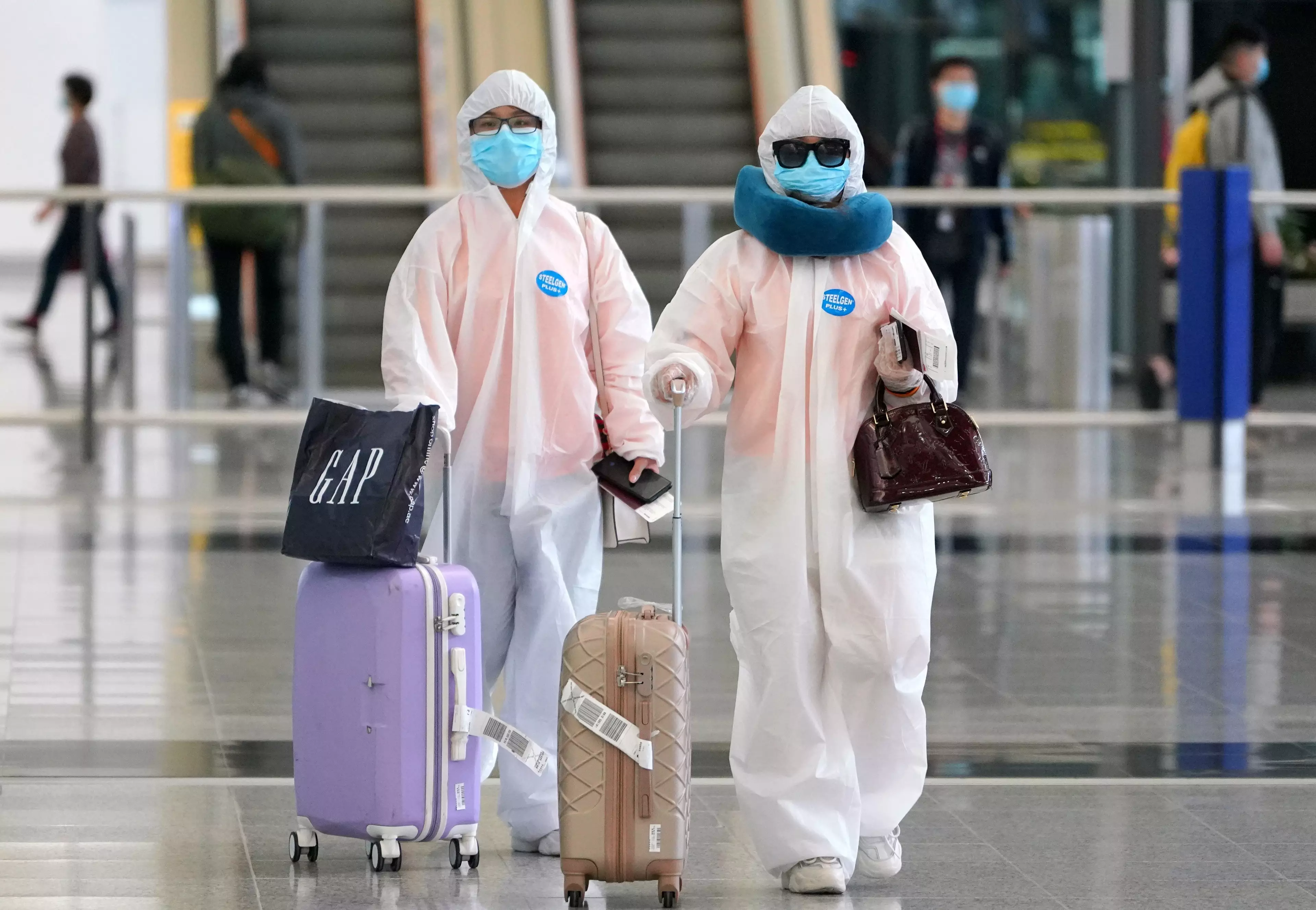 People arriving at Hong Kong Airport.