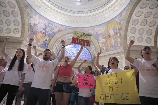 Abortion-rights activists react after lawmakers approved anti-abortion legislation.