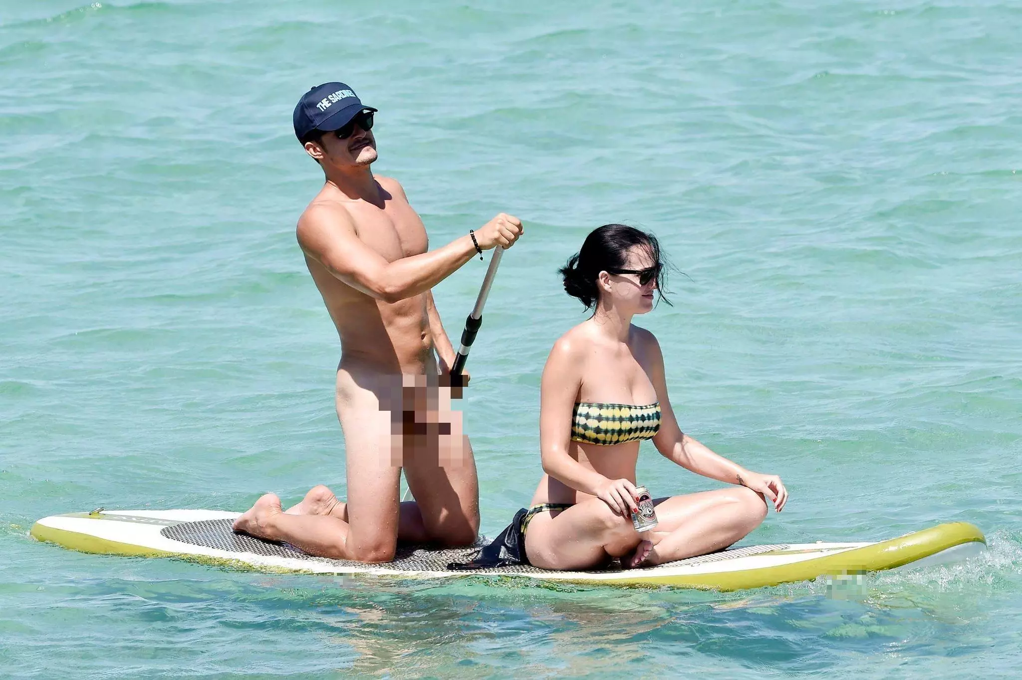 Orlando Bloom was photographed naked on the paddleboard with Katy Perry.