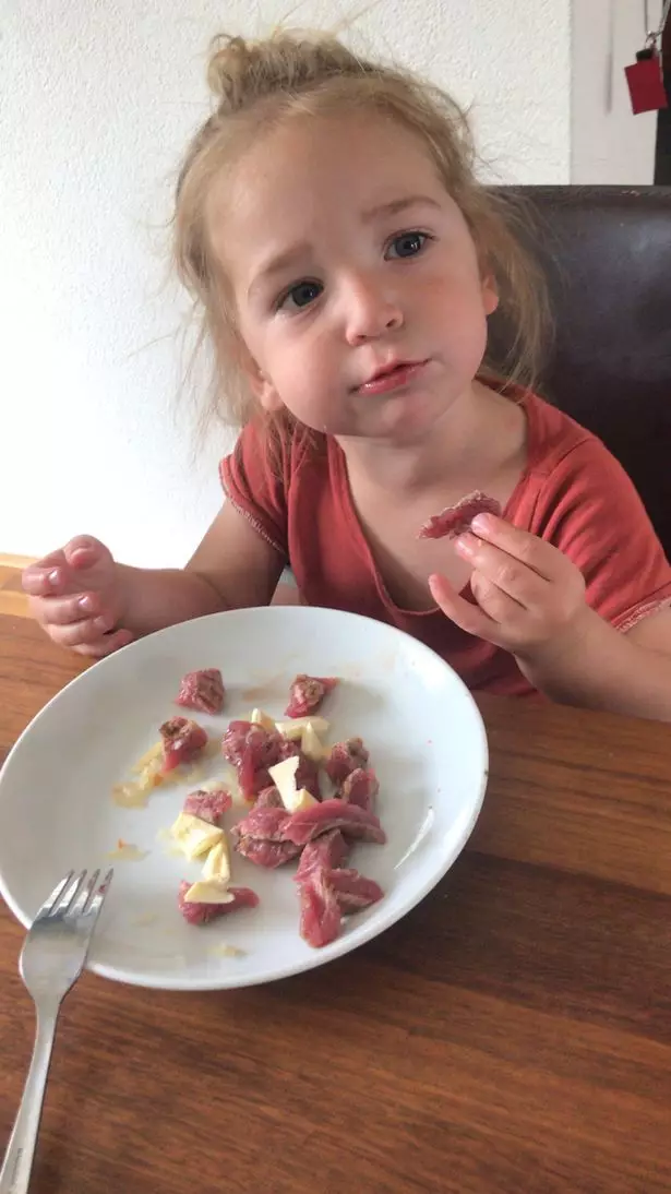 Two-year-old Isaac eats raw steak for breakfast.