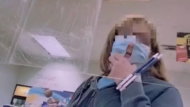 Woman Cuts Hole In Face Mask So That It's Easier To Breathe