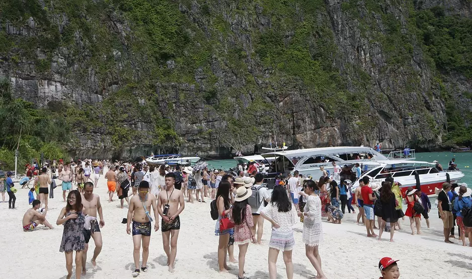 Tourists fill the beach at Maya Bay.