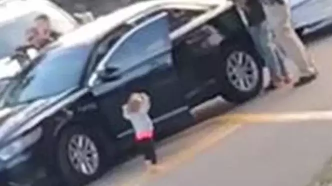 Toddler Walks Towards Armed Police With Her Hands Raised