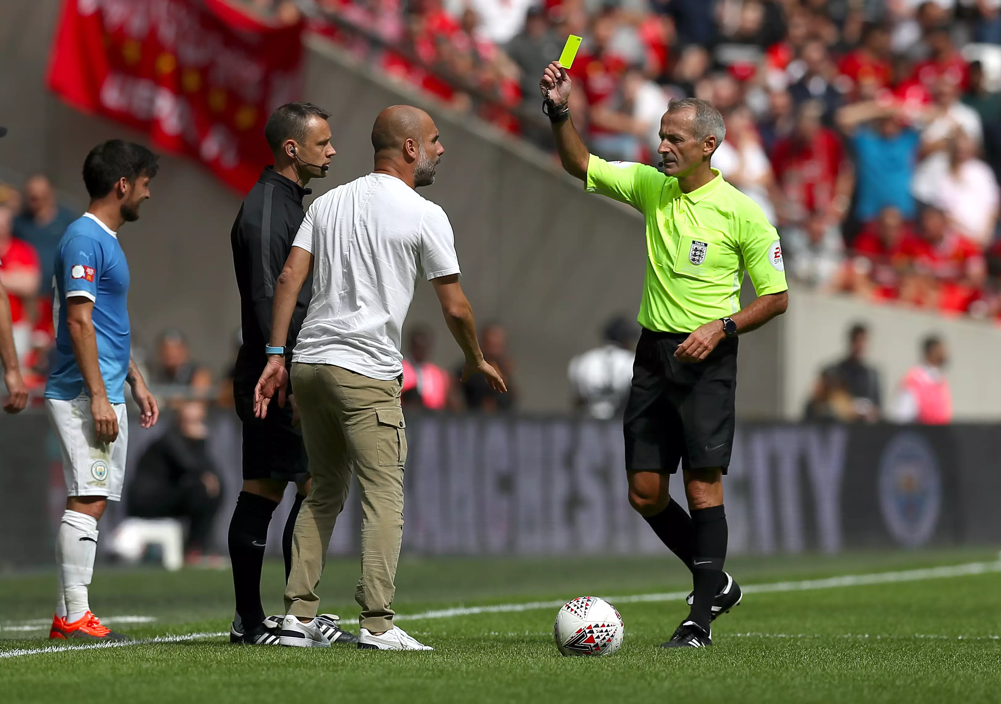 Guardiola picked up his first yellow of the season, kind of. Image: PA Images