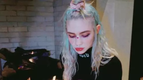Grimes Says She's 'Weirdly Enjoying' It After Catching Covid