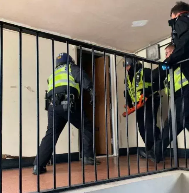 Police break down the doors to the alleged drugs den