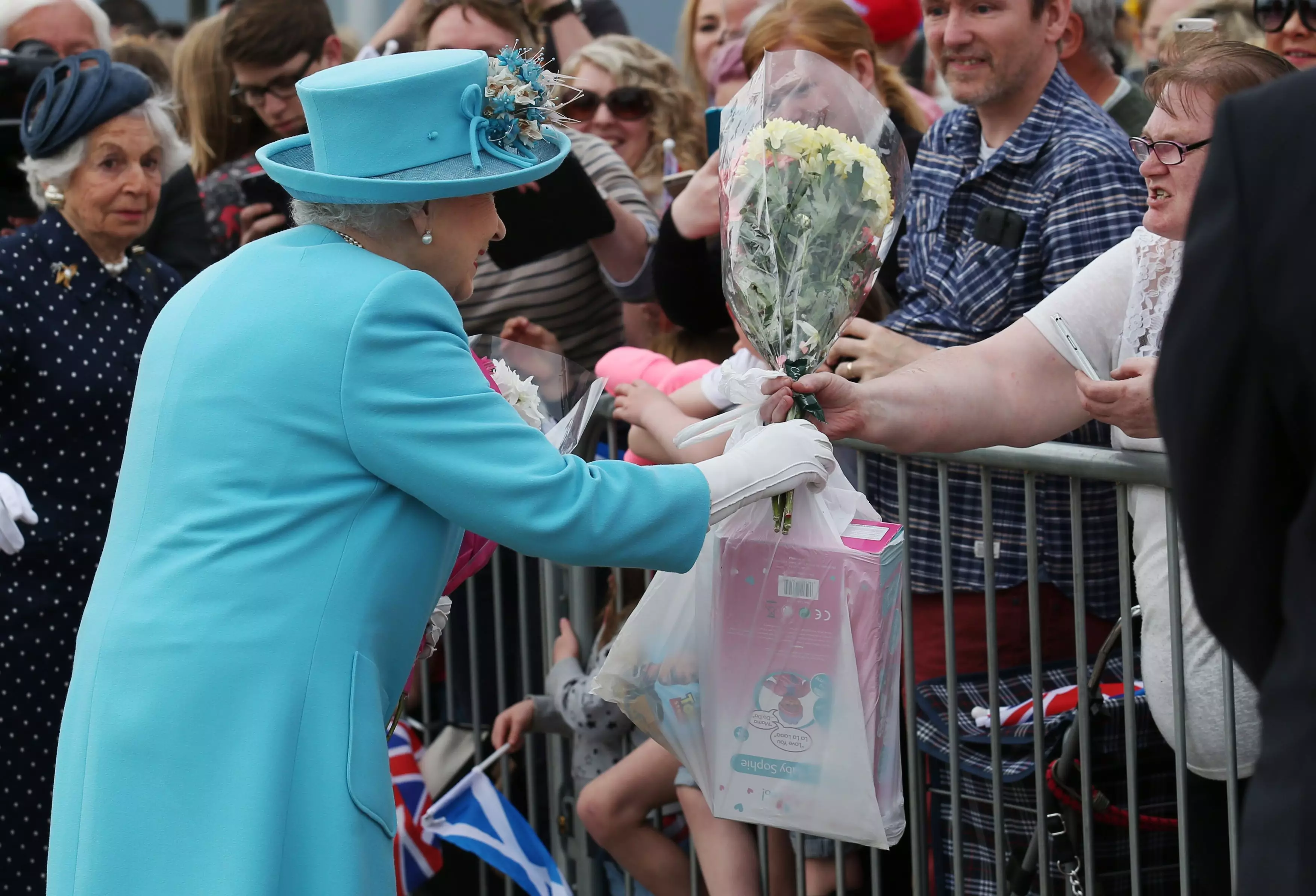 Someone Handed The Queen A B&M Bag Of Toys And She Did Not Look Impressed