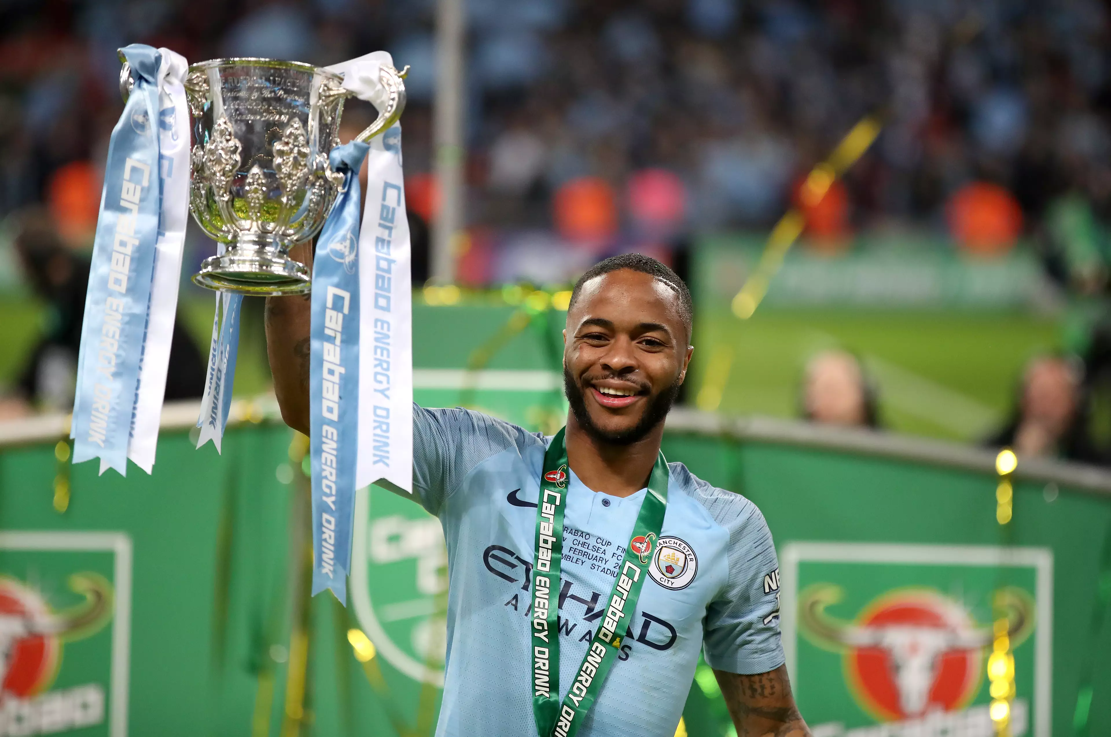 Raheem Sterling lifts the Carabao Cup after victory over Chelsea in the final