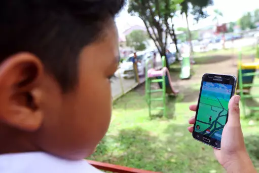 Indonesian school children play 'Pokemon Go' which uses Google Maps.