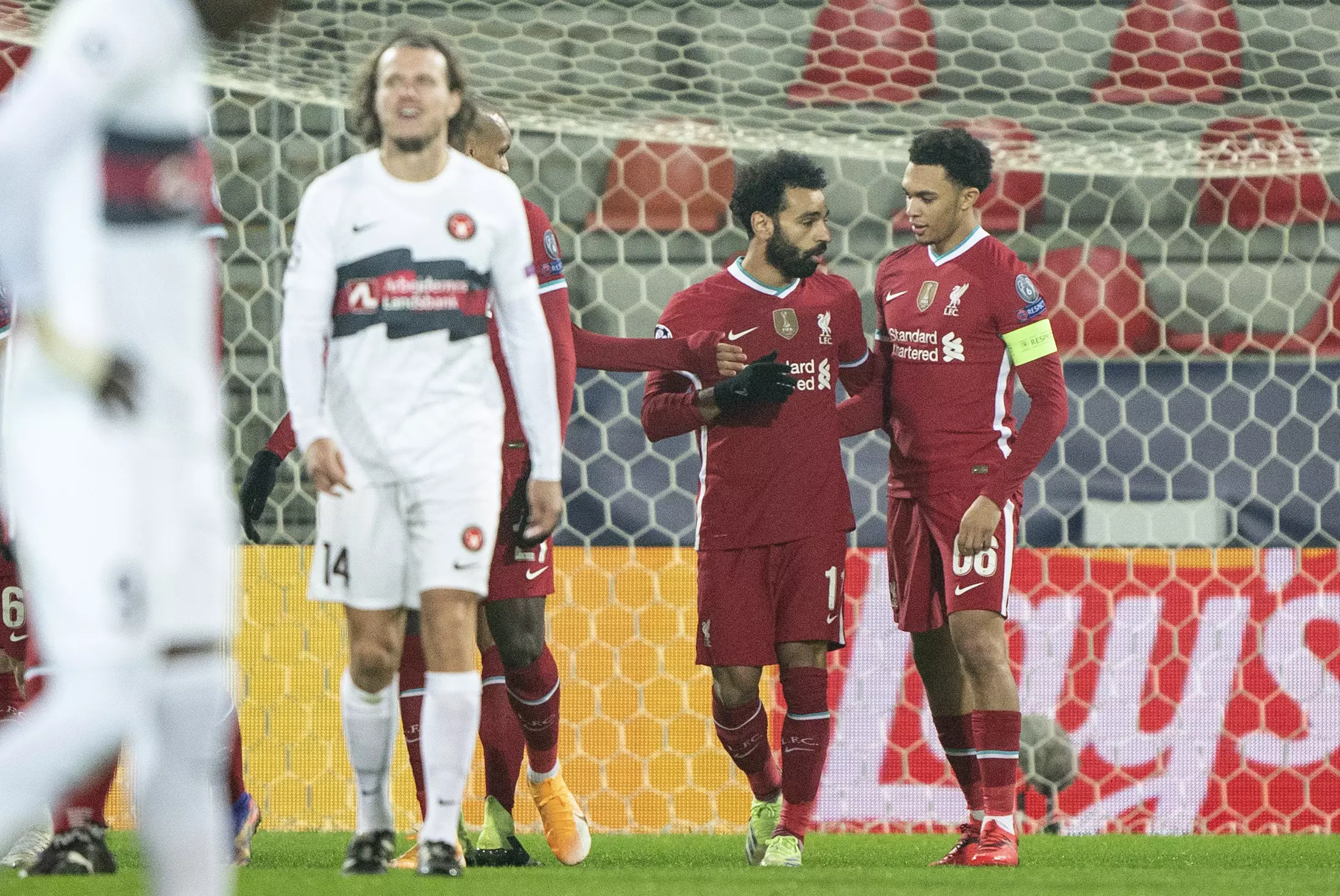 Salah celebrates with captain Trent. Image: PA Images