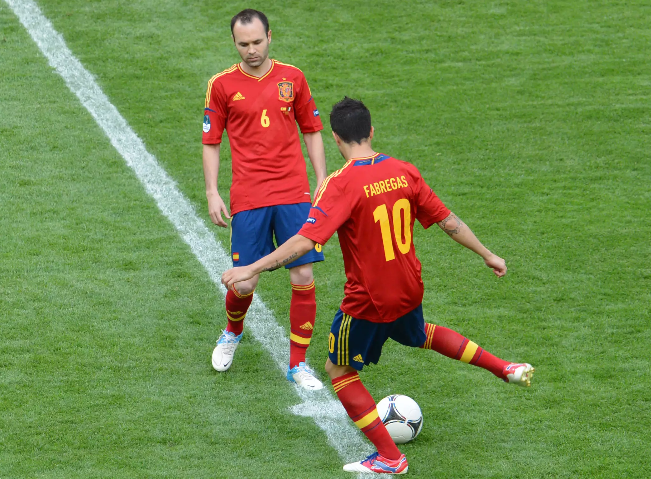 Fabregas and Iniesta playing together for Spain. Image: PA Images