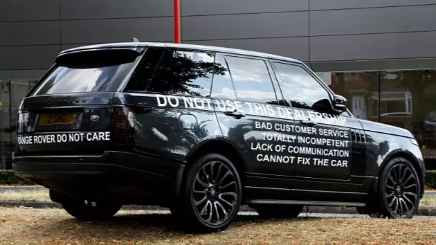 Furious Driver Parks Range Rover Covered With Warnings Outside Dealership