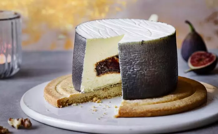 This looks like a cheese wheel but it's actually a cheesecake (