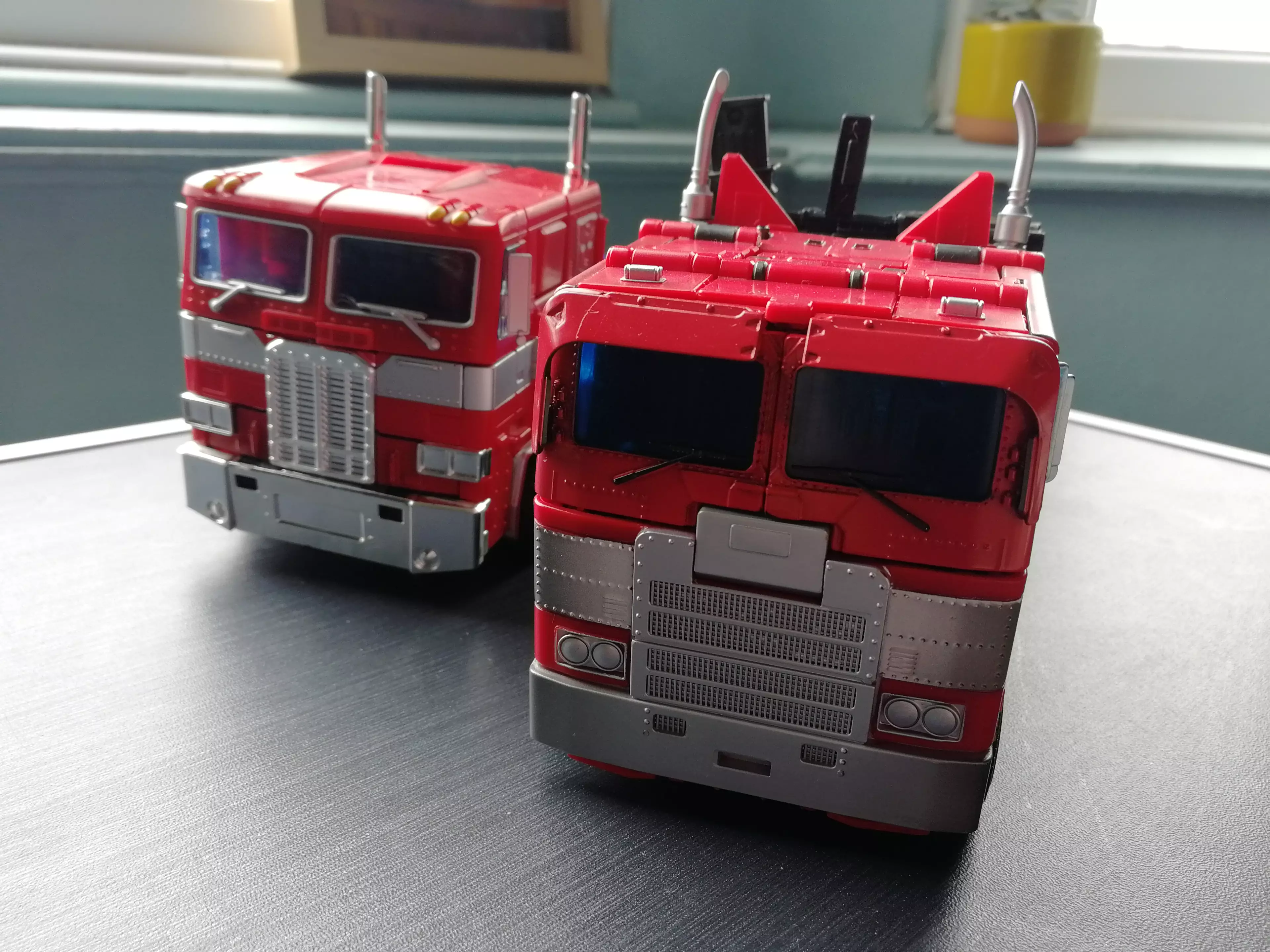 MPM-12's truck mode (right) beside MP10's - his backside, not pictured (but that is his gun, poking out) / credit: the author