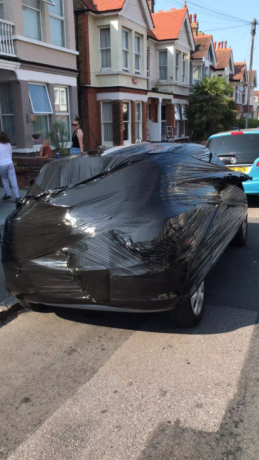 Tobe Bailey wrapped the offending car in cellophane after it blocked his driveway for a day and a half (