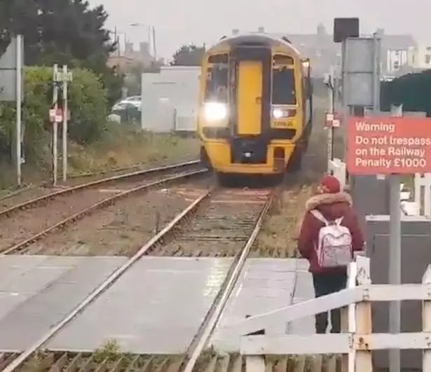 The woman ended up waiting at the side and the driver got off the train.