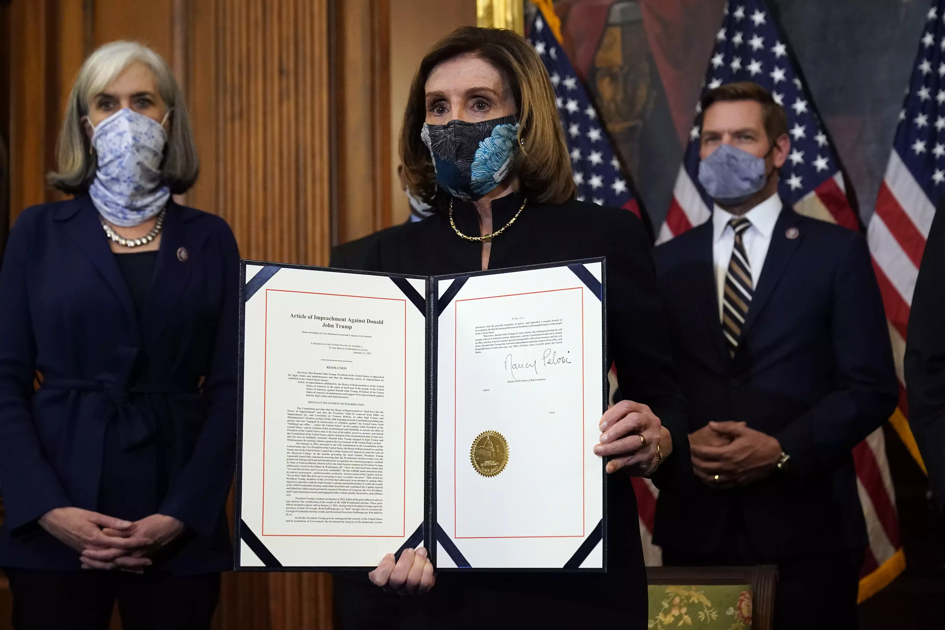 House Speaker Nancy Pelosi signing the article of impeachment.