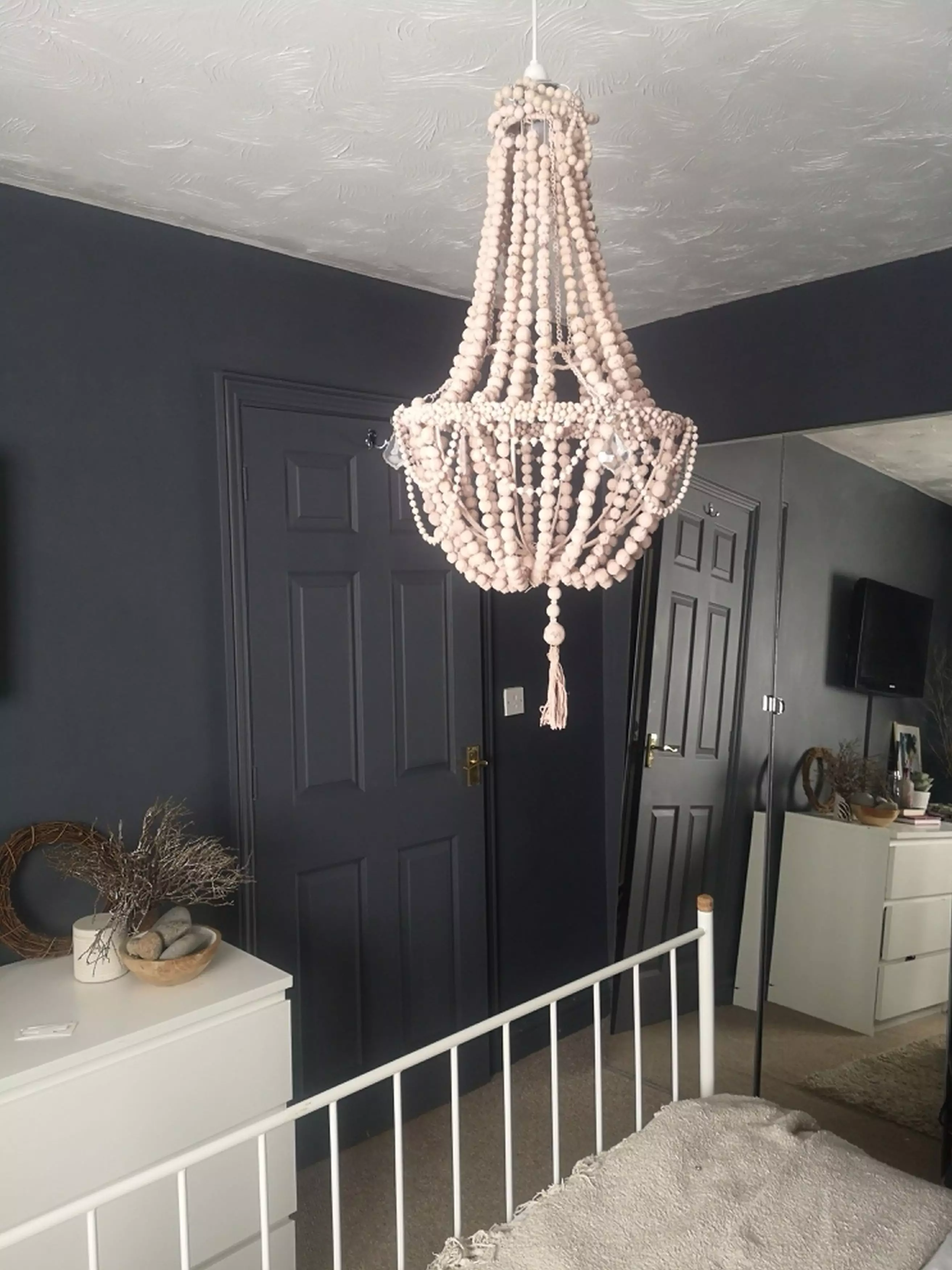 Her pasta chandelier now takes pride of place above her bed (