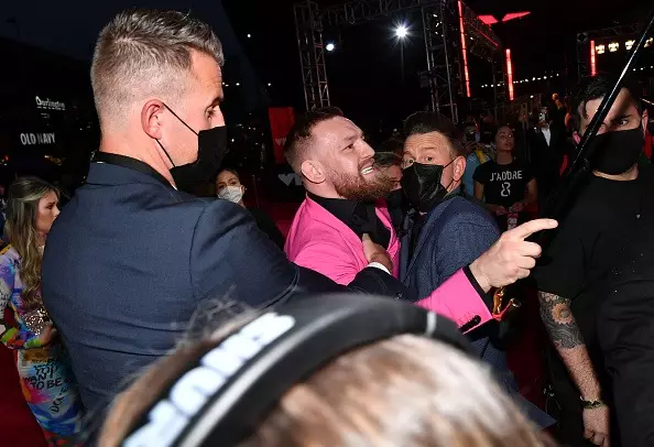 McGregor had to be held back by security as he shouted at MGK.