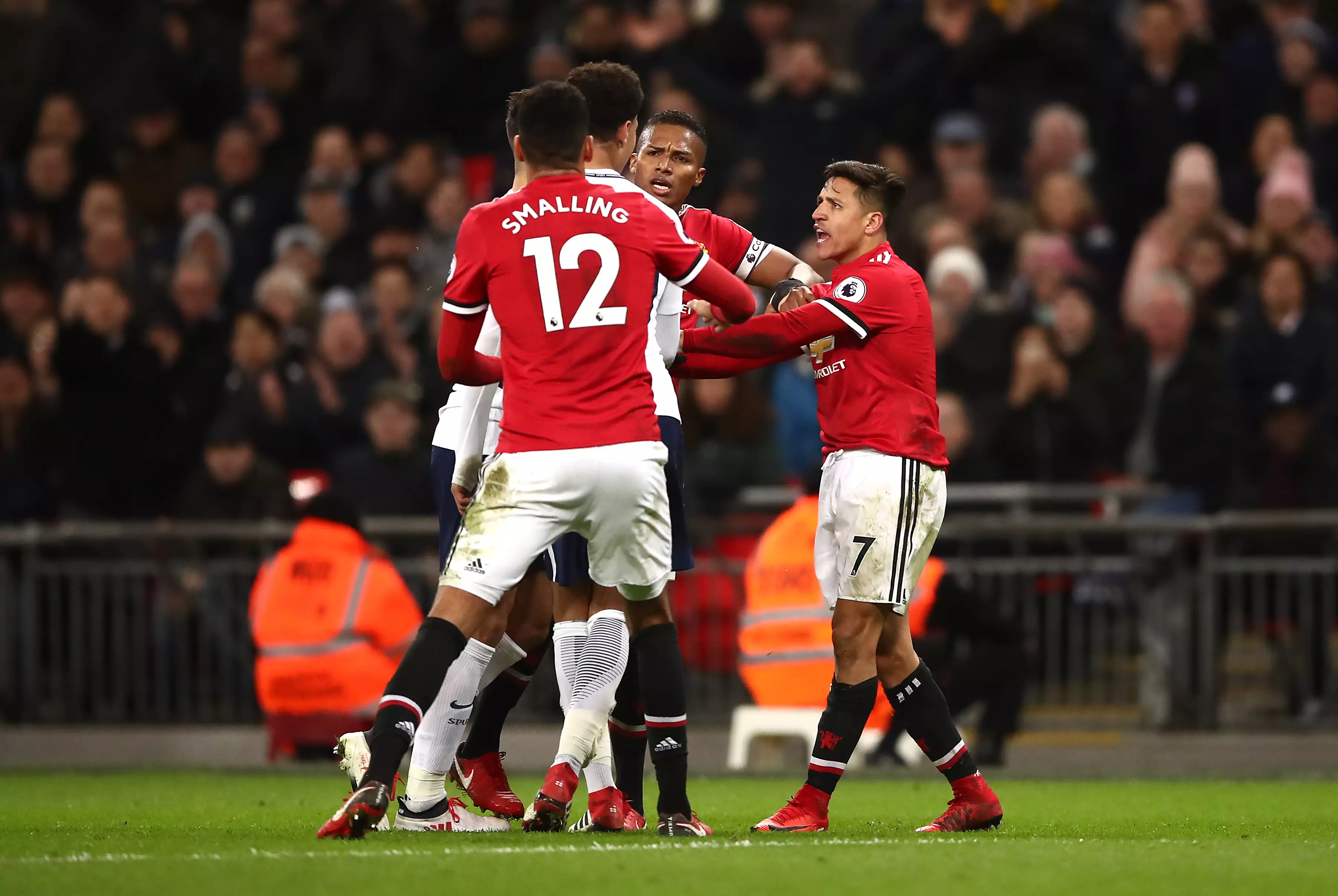 Dele exchanges words with United's Alexis. Image: PA